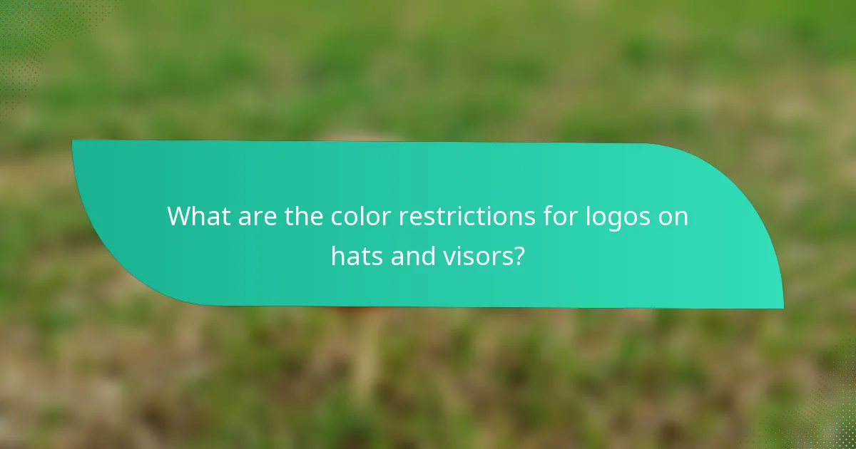 What are the color restrictions for logos on hats and visors?